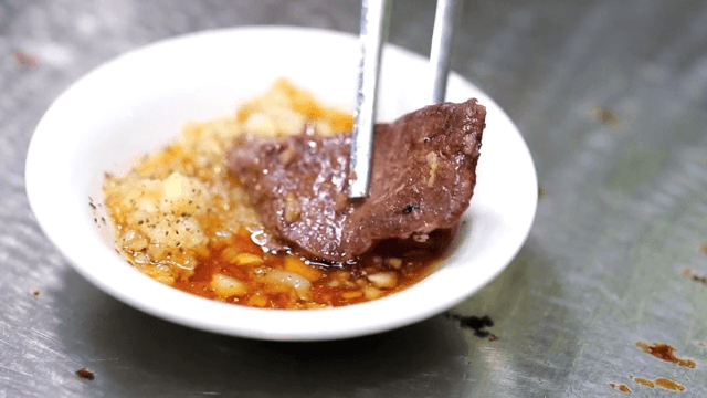 Beef tripe grilled over briquette fire