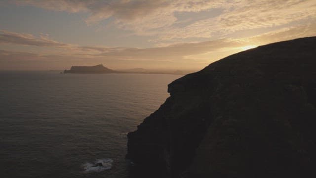 Sunset over the ocean with distant islands