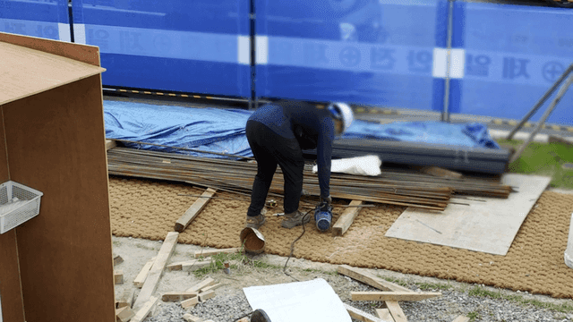 건설 현장에서 철근을 자라는 작업자들