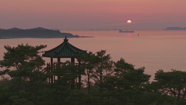 Serene sunset over the sea with a old pavilion