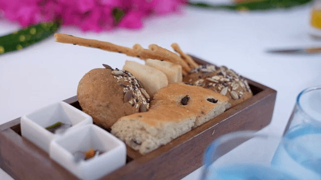A variety of breads on a wooden tray