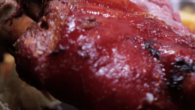 Cutting roast pork with scissors