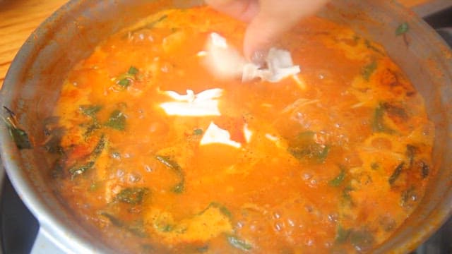 Hand-pulled dough added to napa cabbage and pork backbone stew