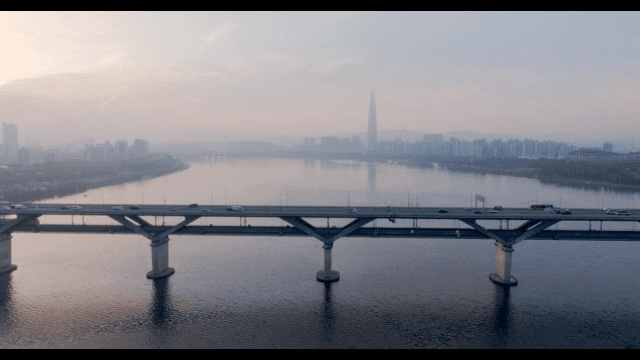 Bridge over a river with city skyline