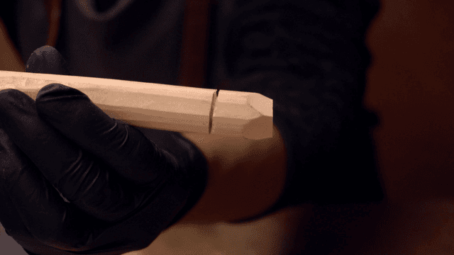 Person carving a wooden stick