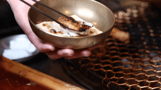 Grilled chicken dipped in sauce at barbecue