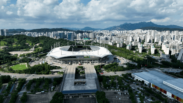 Large stadium surrounded by downtown buildings