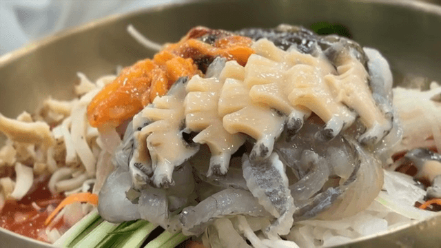 Preparing Cold Raw Fish Soup with fresh abalone on top