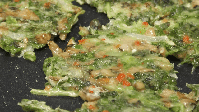 Cilantro pancakes cooking in pan
