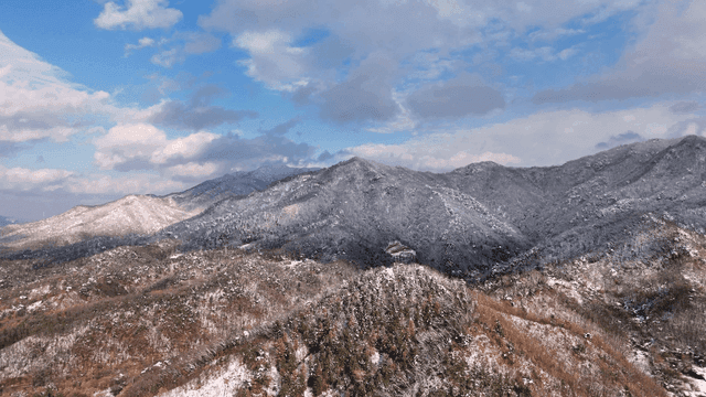 Snow-covered mountains under a blue sky