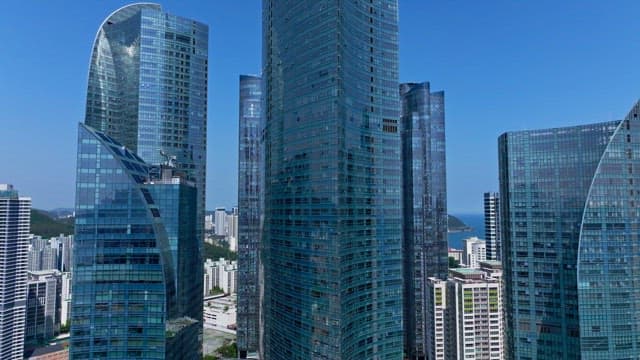 Unique, glass-windowed skyscraper under sunny sky