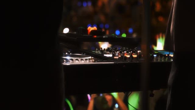 Two DJs performing at a vibrant night event