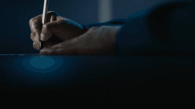 Hand writing with a pen on paper