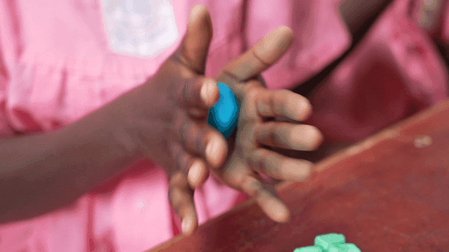 Child molding clay with focus and care