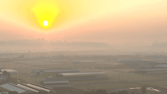 Sunrise over a misty rural landscape
