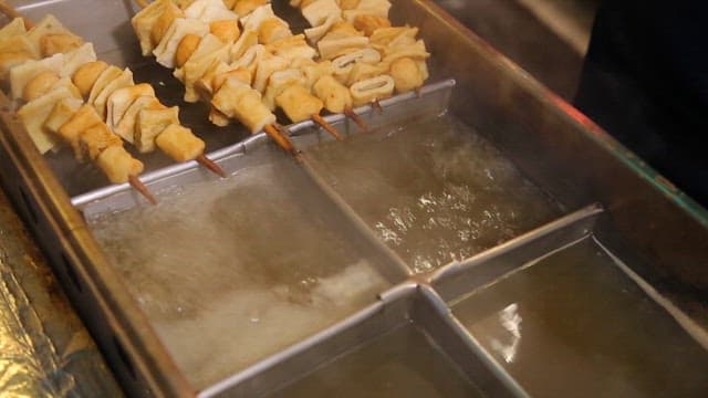 Fish cake skewers boiling in broth