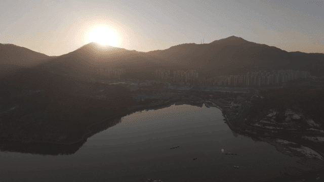 Sunrise over mountains and cityscape