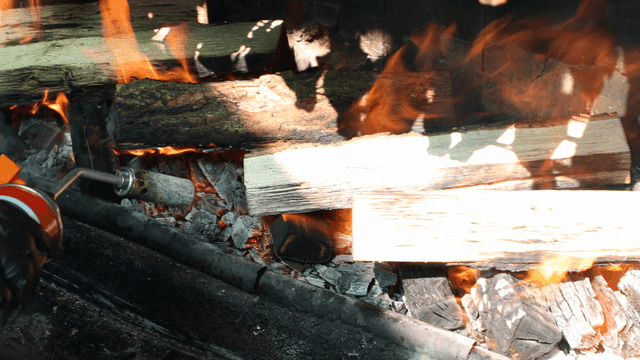 Wood being ignited with a torch