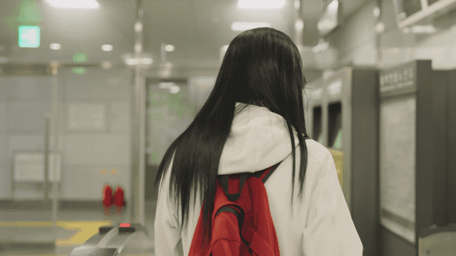 Young woman exiting subway gate