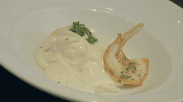 Shrimp with creamy sauce in a white bowl