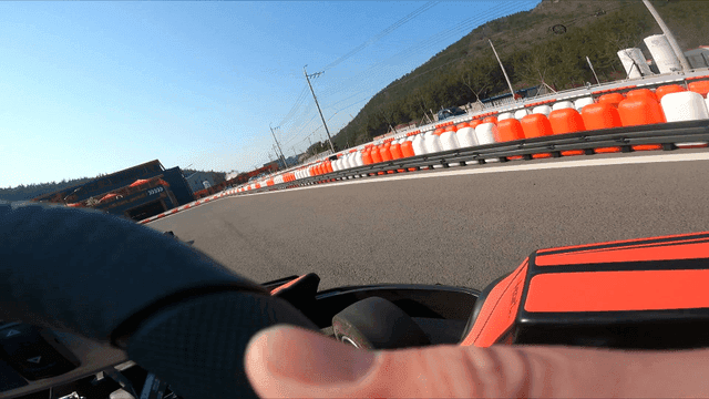 Go-kart racing on a sunny outdoor track
