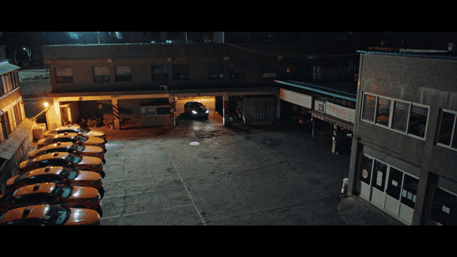 Cars entering taxi parking lot at night