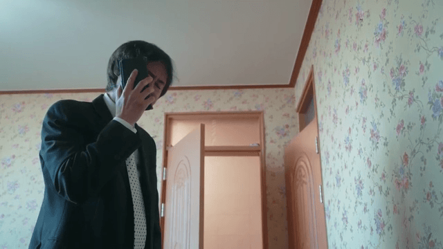 Man leaves room after phone call