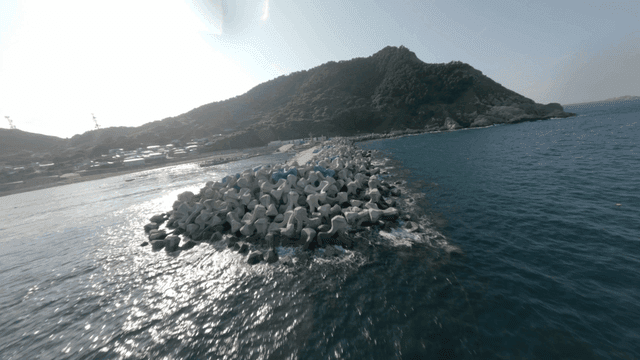 A coastal landscape with a breakwater