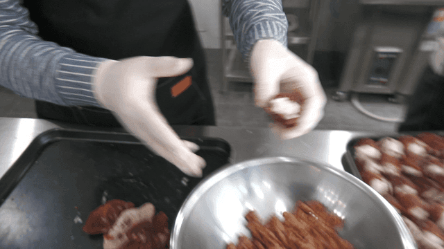 Filling dried persimmons with cream cheese in kitchen
