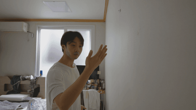 Man looking at his hand after catching a bug