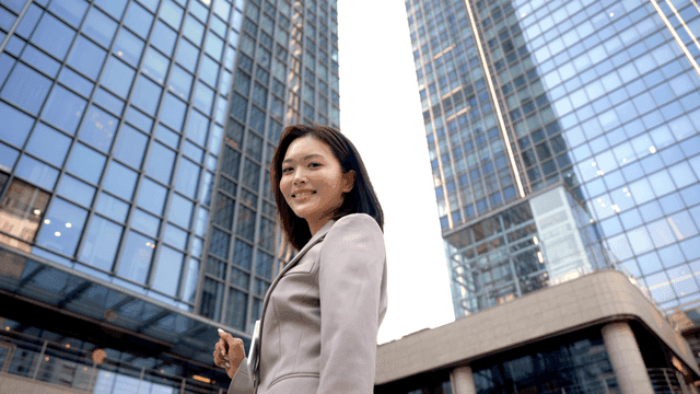 Confident female entrepreneur in front of high-rise building