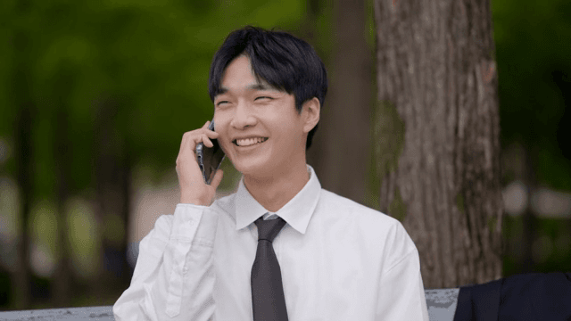 Office worker sitting on a bench, smiling and talking on the phone