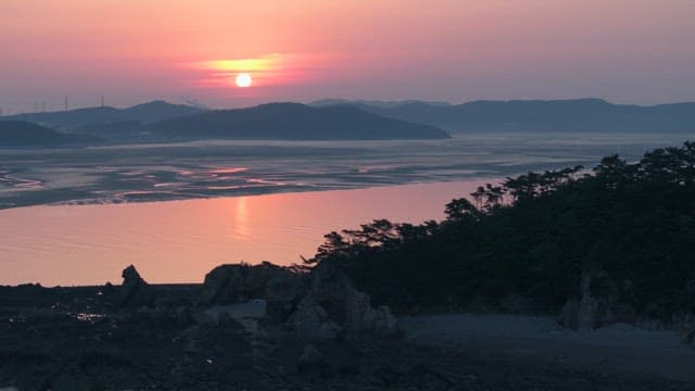 Serene Sunrise Over Coastal Landscape