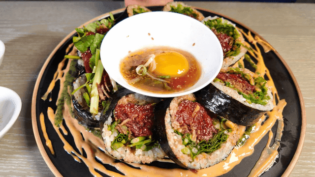 Thick raw beef gimbap served with sauce