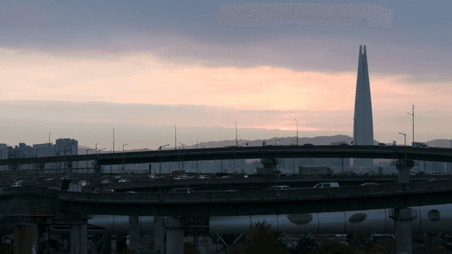 Highway and city skyline at sunset
