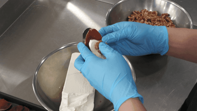 Person who puts walnuts and cream cheese in dried persimmons