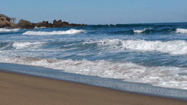 Waves crashing on a sandy beach
