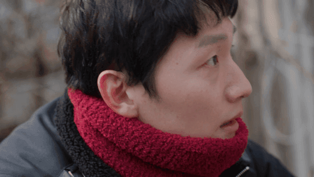A person wearing a red scarf outdoors