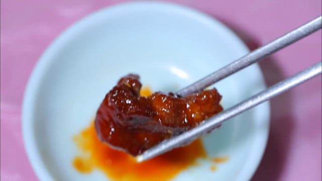 Chopstickful of spicy pork ribs