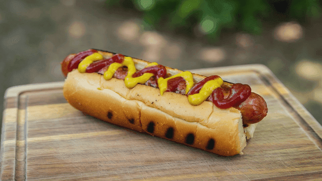 Hot dog topped with ketchup and mustard
