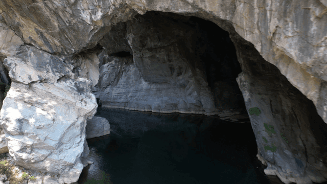 Clear stream beneath quiet cave