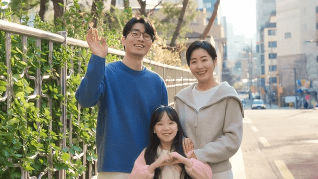Family smiling on a sunny street