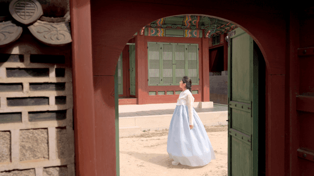 Traditional Korean house with a woman in hanbok