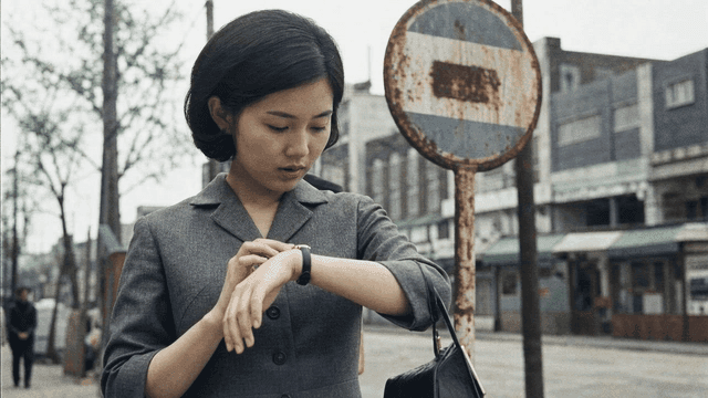 Woman looking at her watch on street in 70s