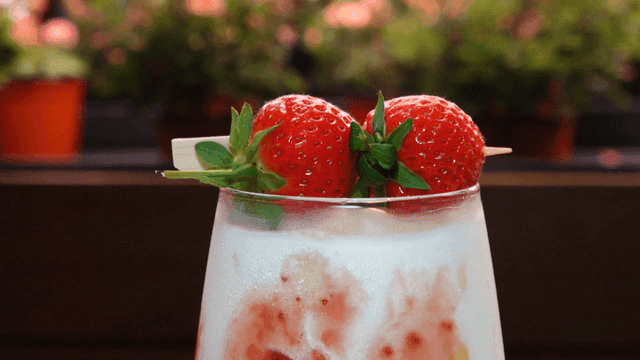 Refreshing strawberry latte in a glass cup