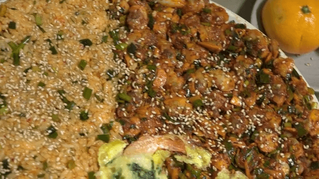 Plate of bibimbap, cockle salad, and shrimp pancake