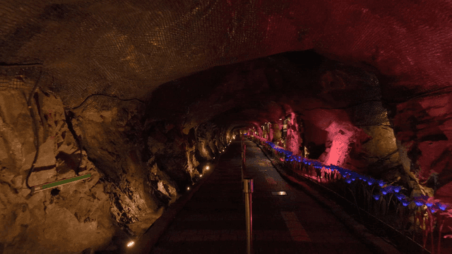 Illuminated cave tunnel with colorful lights