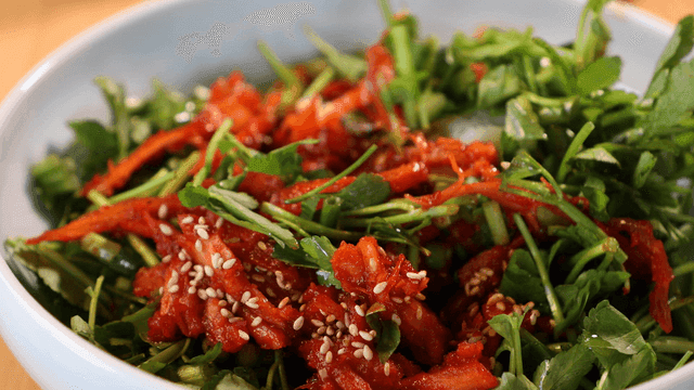 Spoon for mixing seasoned deodeok and water parsley bibimbap