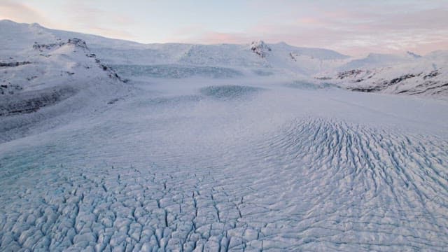 Vast glacier with snowy mountains