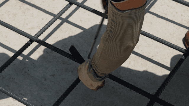 Worker tying rebar at a construction site